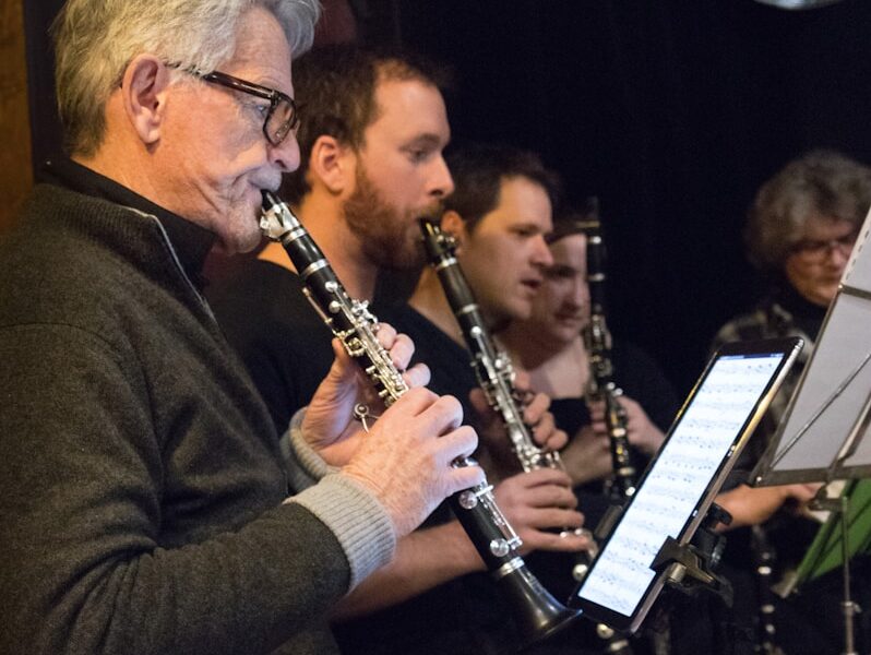 a group of people playing musical instruments in a room