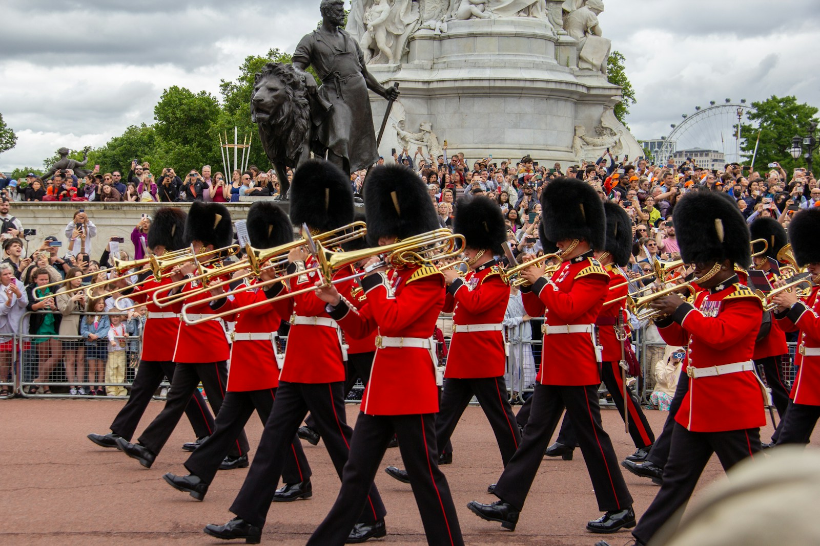 A group of men in red uniforms marching down a street